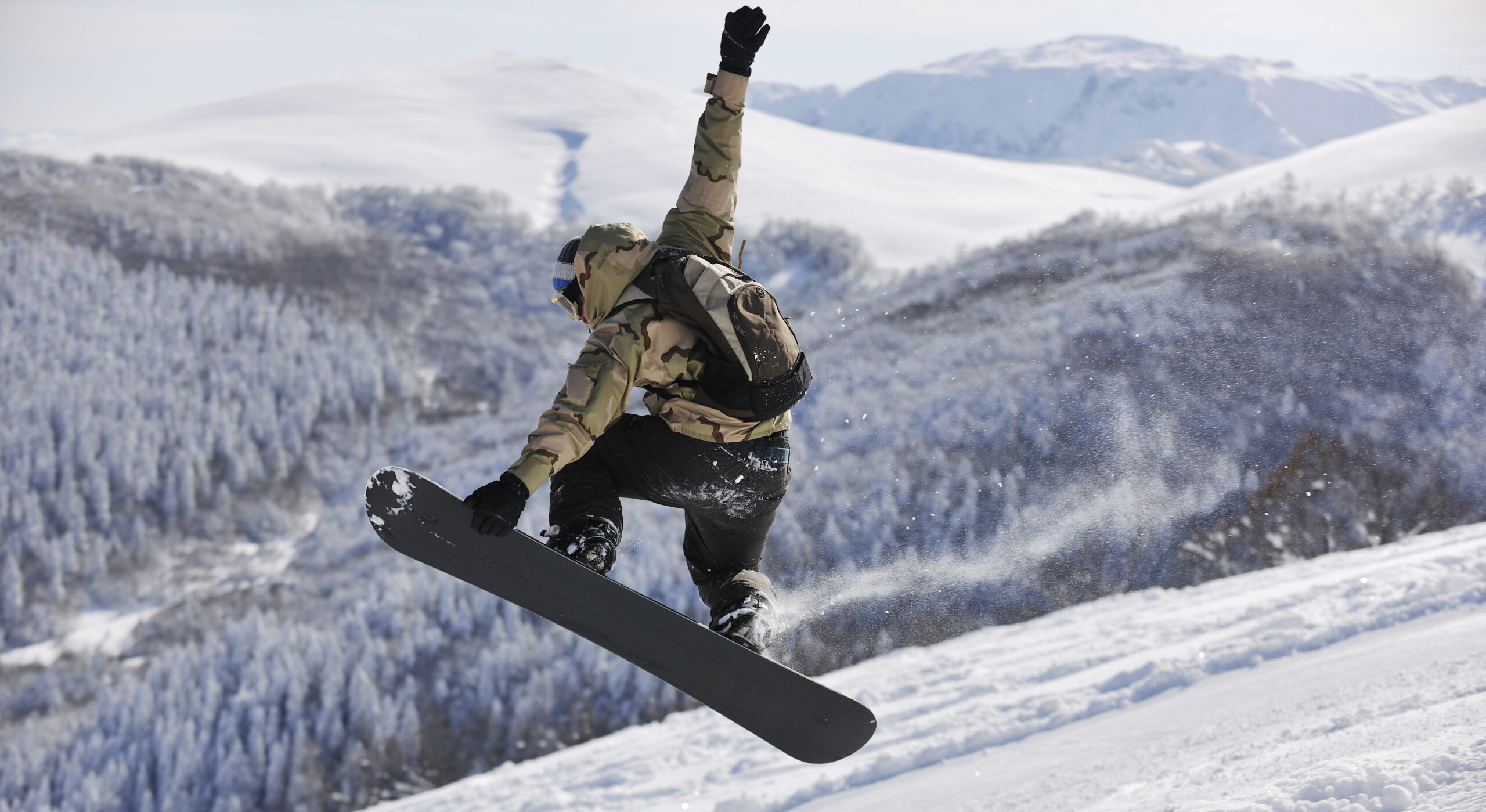 freestyle snowboarder jump and ride